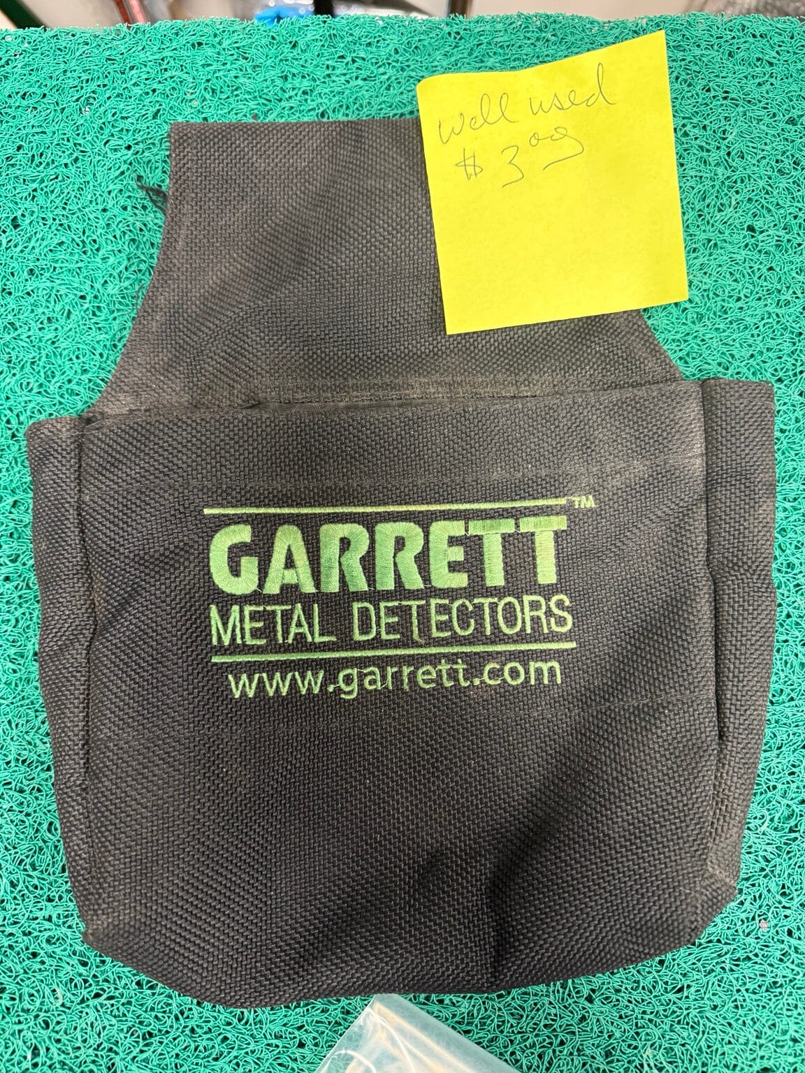 Well used Garrett Metal Detectors black finds pouch